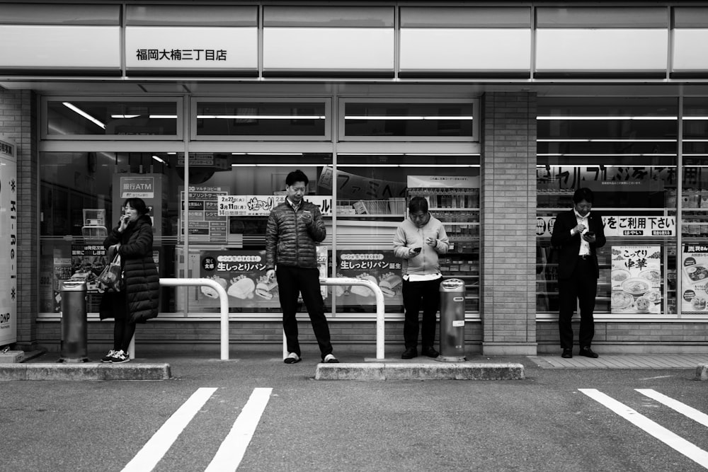 a group of people standing in front of a store