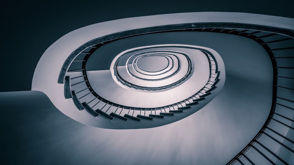 a spiral staircase in a building with a circular railing