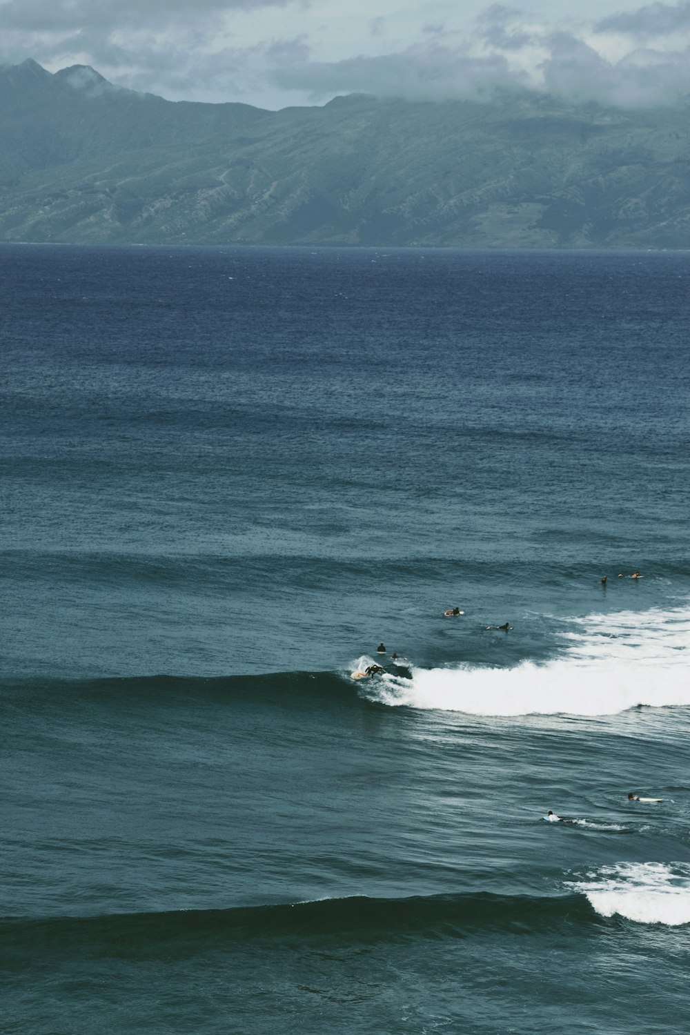 a group of surfers riding the waves in the ocean