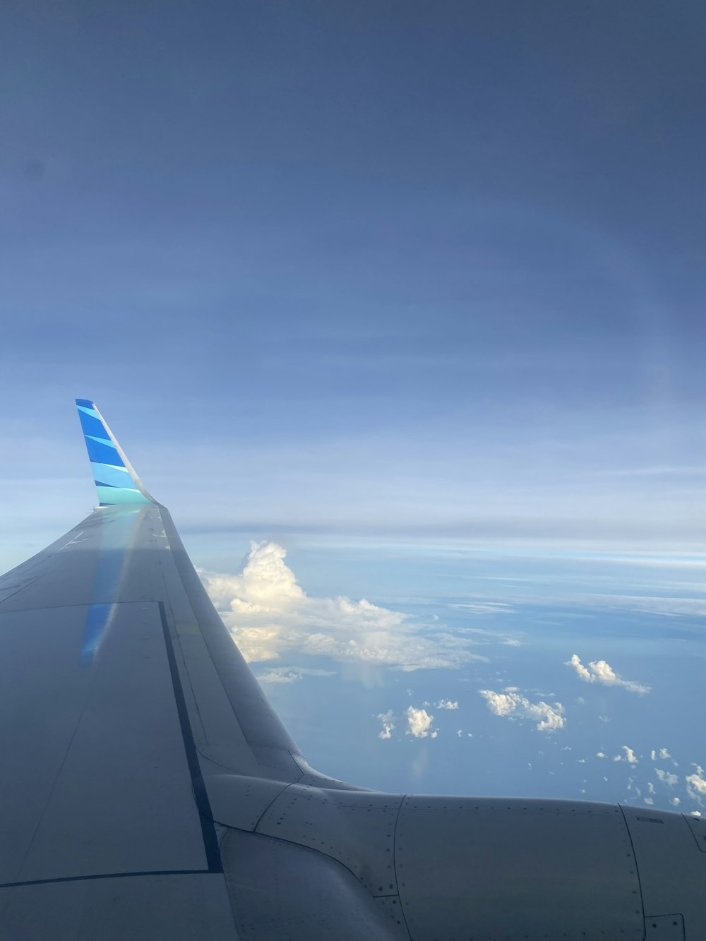 a view of the wing of an airplane in the sky