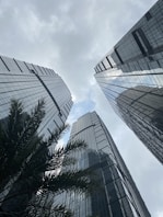 a couple of tall buildings sitting next to each other