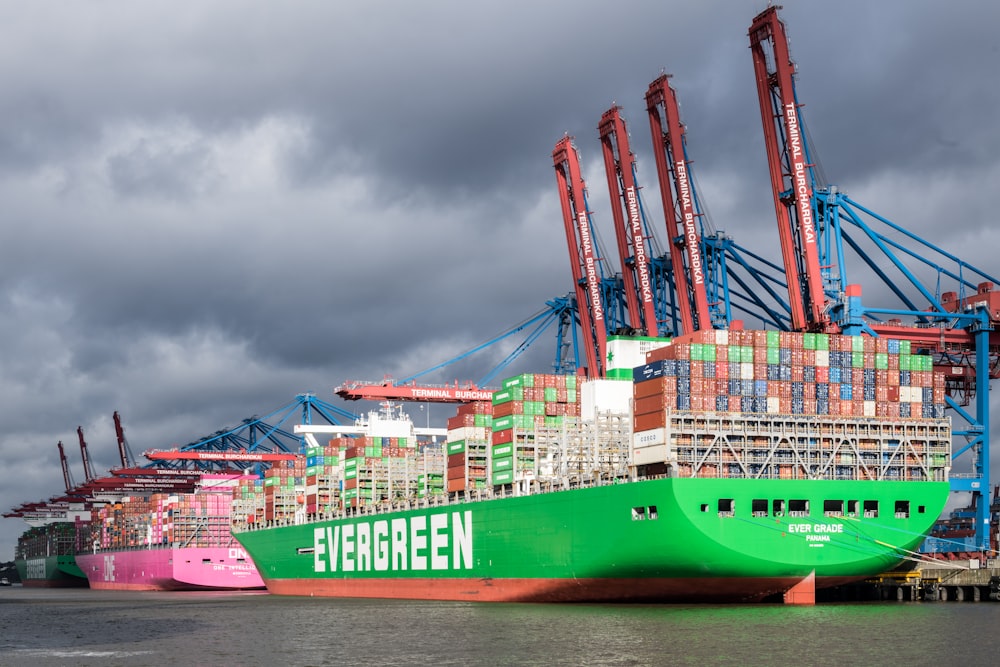 a large green and pink boat in the water