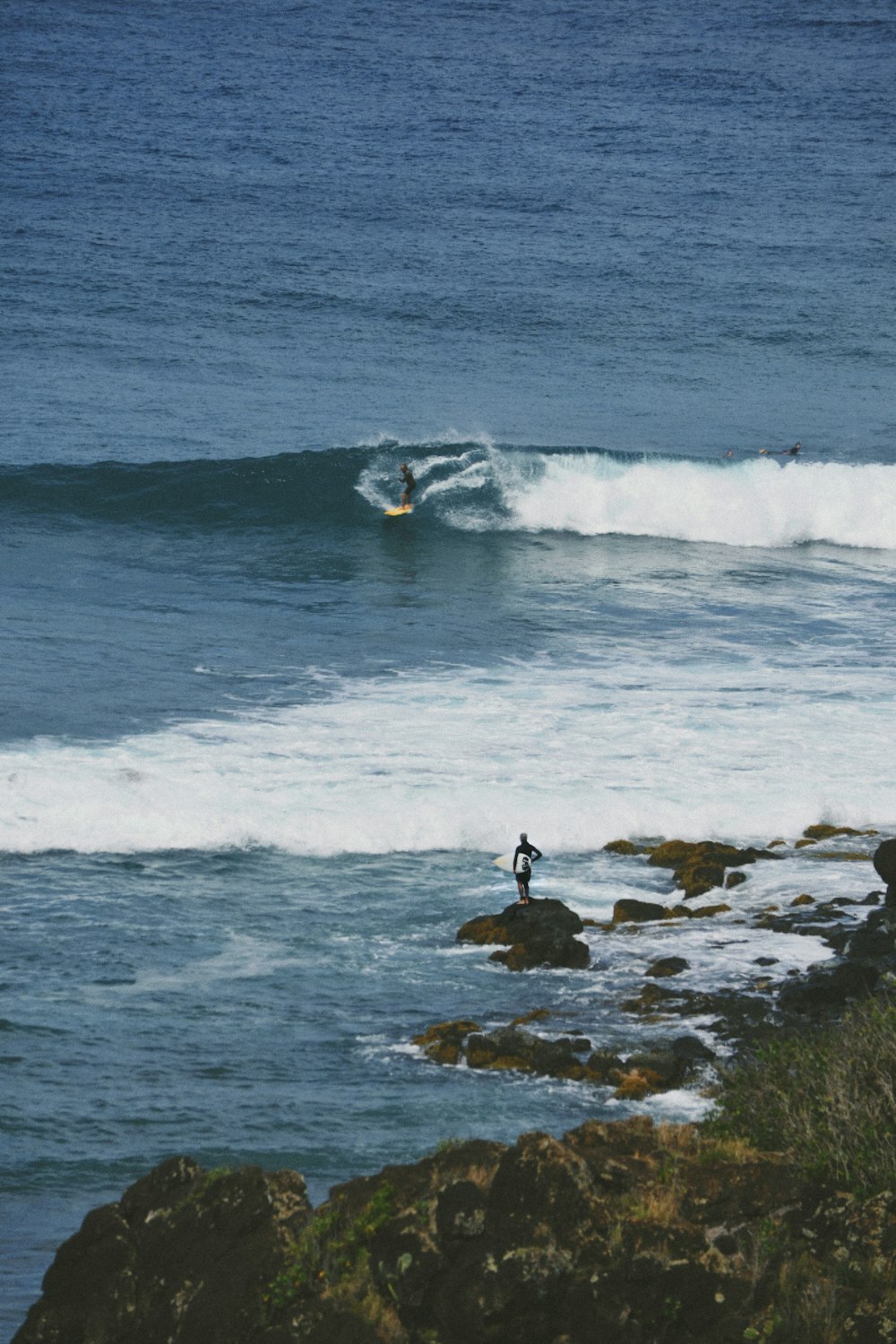 a man riding a wave on top of a surfboard