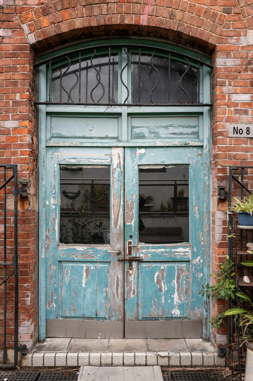 a blue door with a brick wall behind it