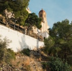 a church on top of a hill surrounded by trees