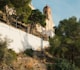 a church on top of a hill surrounded by trees