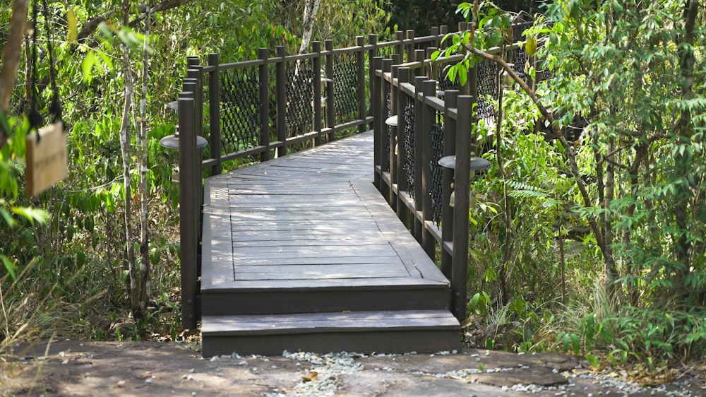 a wooden bridge in the middle of a forest