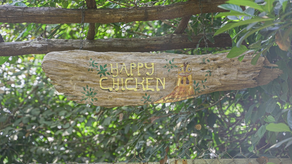 a wooden sign that says happy chicken on it