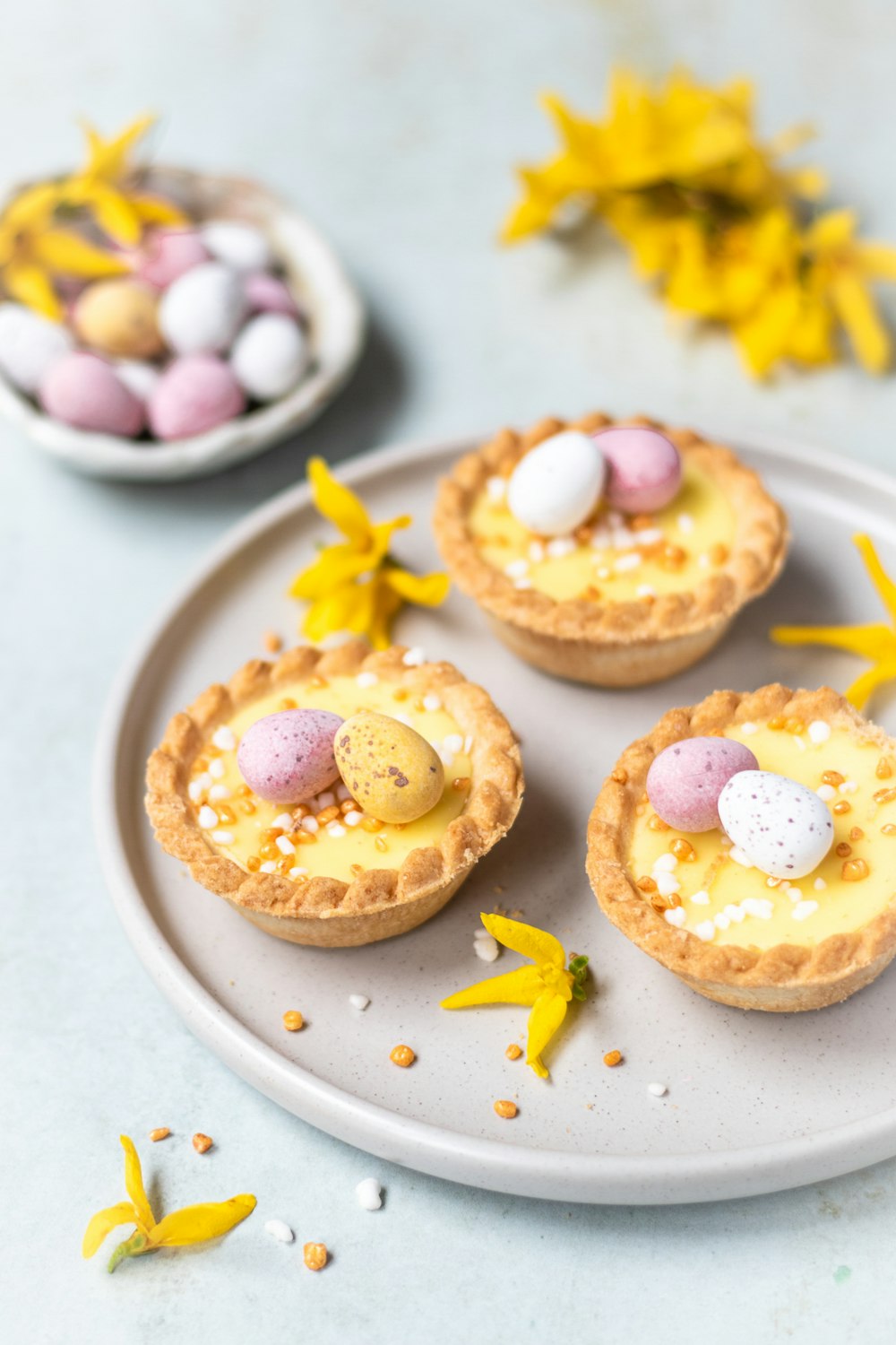 a plate of mini pies with eggs on them