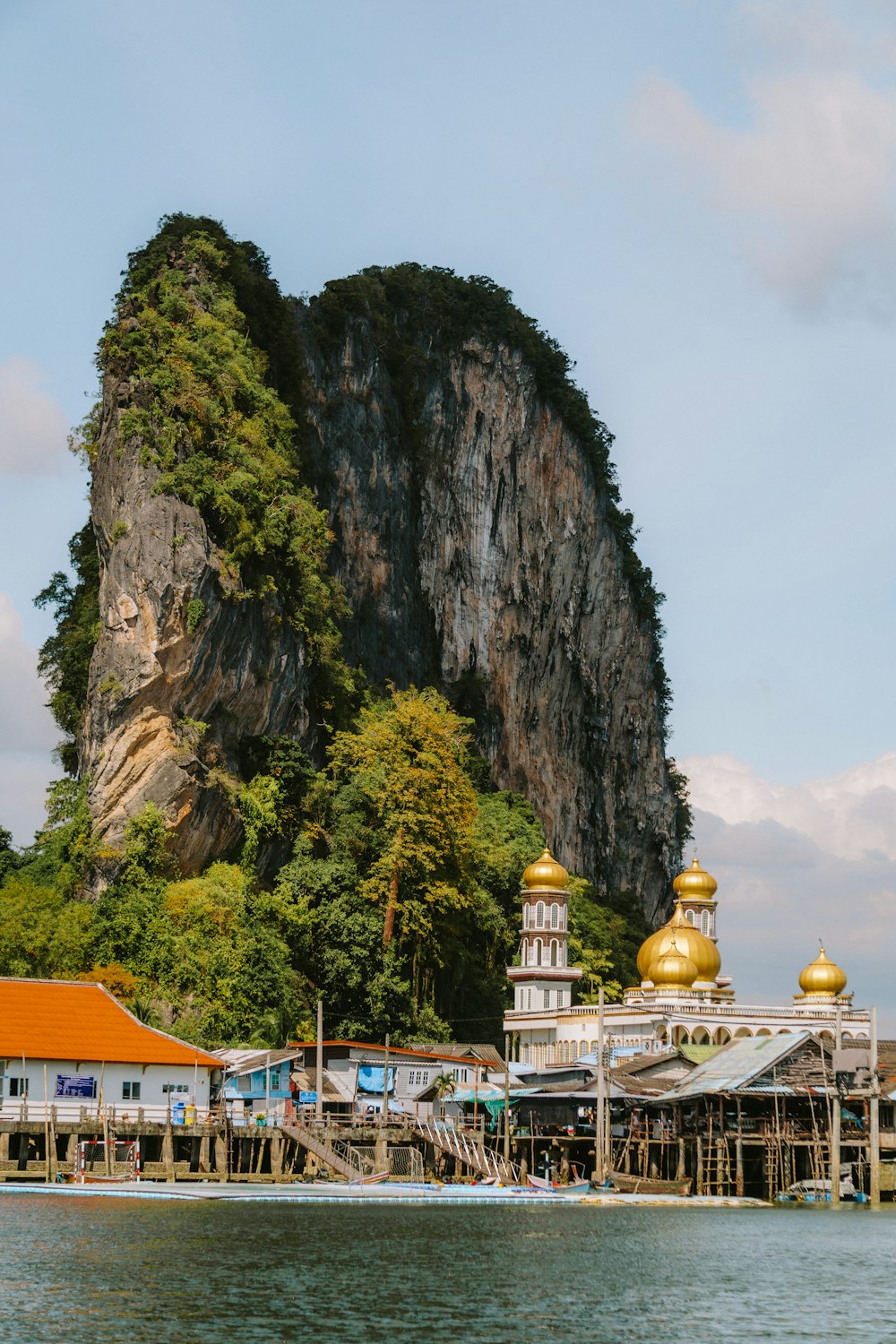 a large mountain in the middle of a body of water