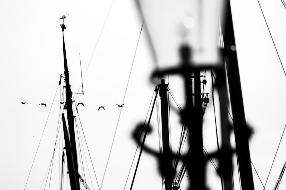a black and white photo of a boat mast