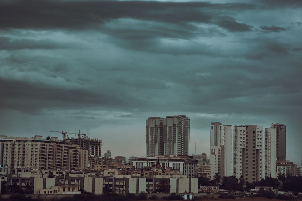 a city with tall buildings under a cloudy sky