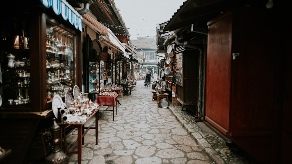 a narrow street lined with shops and vendors