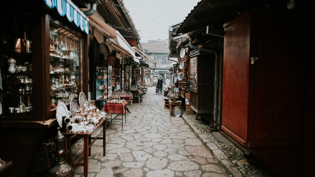 a narrow street lined with shops and vendors,