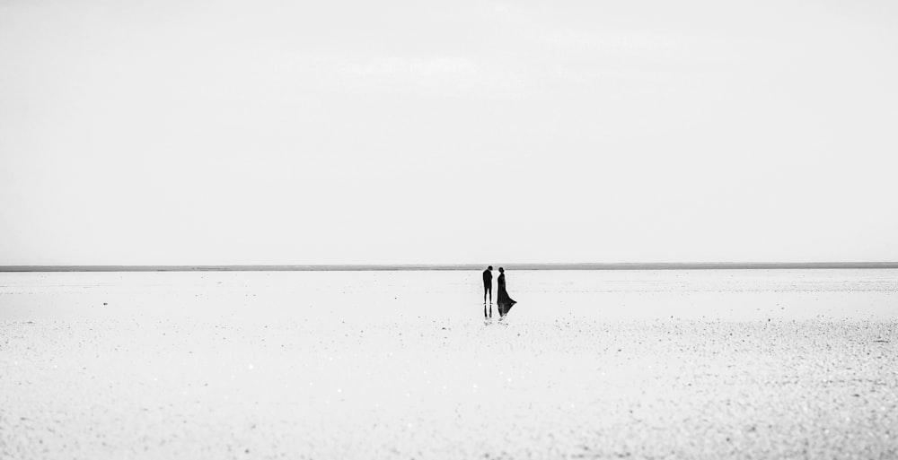 a couple of people standing in the middle of a field