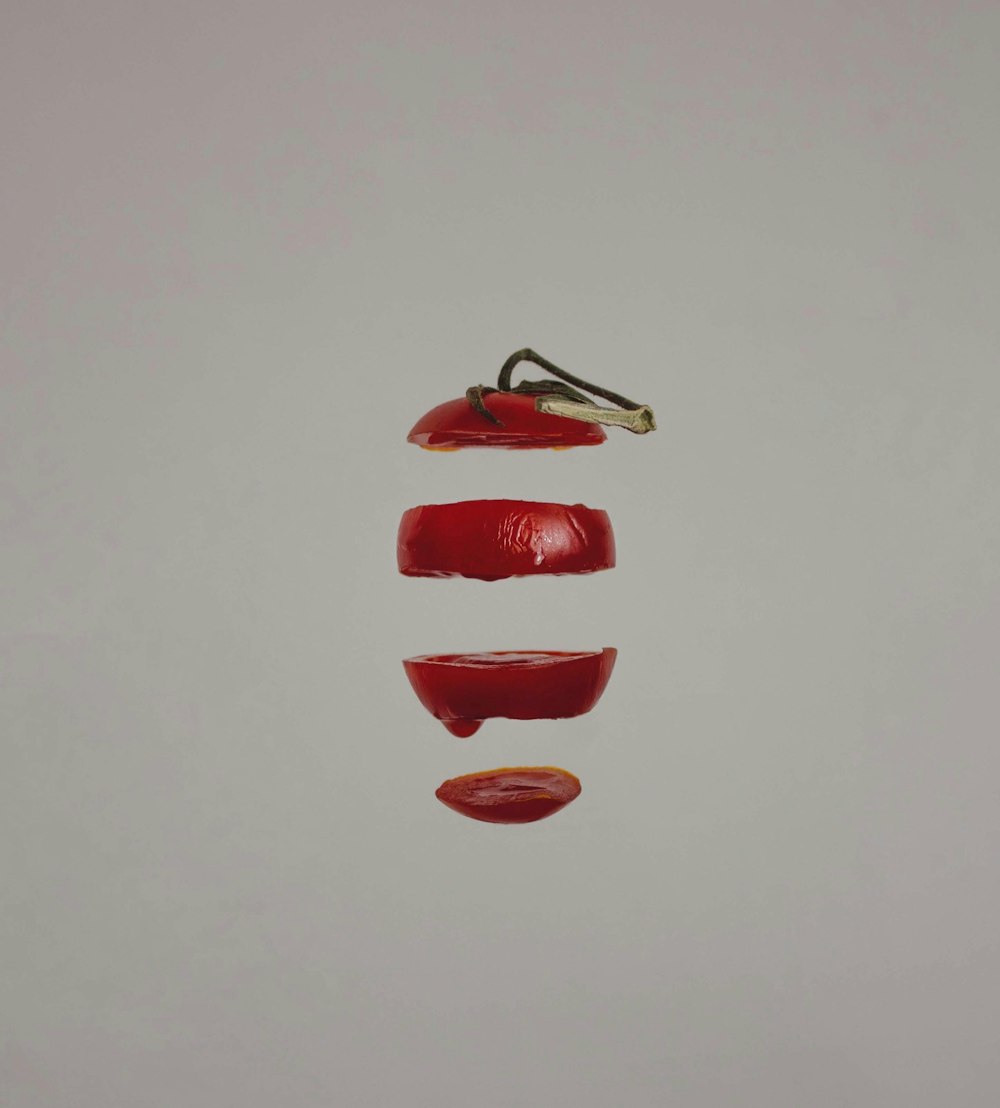 a group of three pieces of fruit hanging from a string