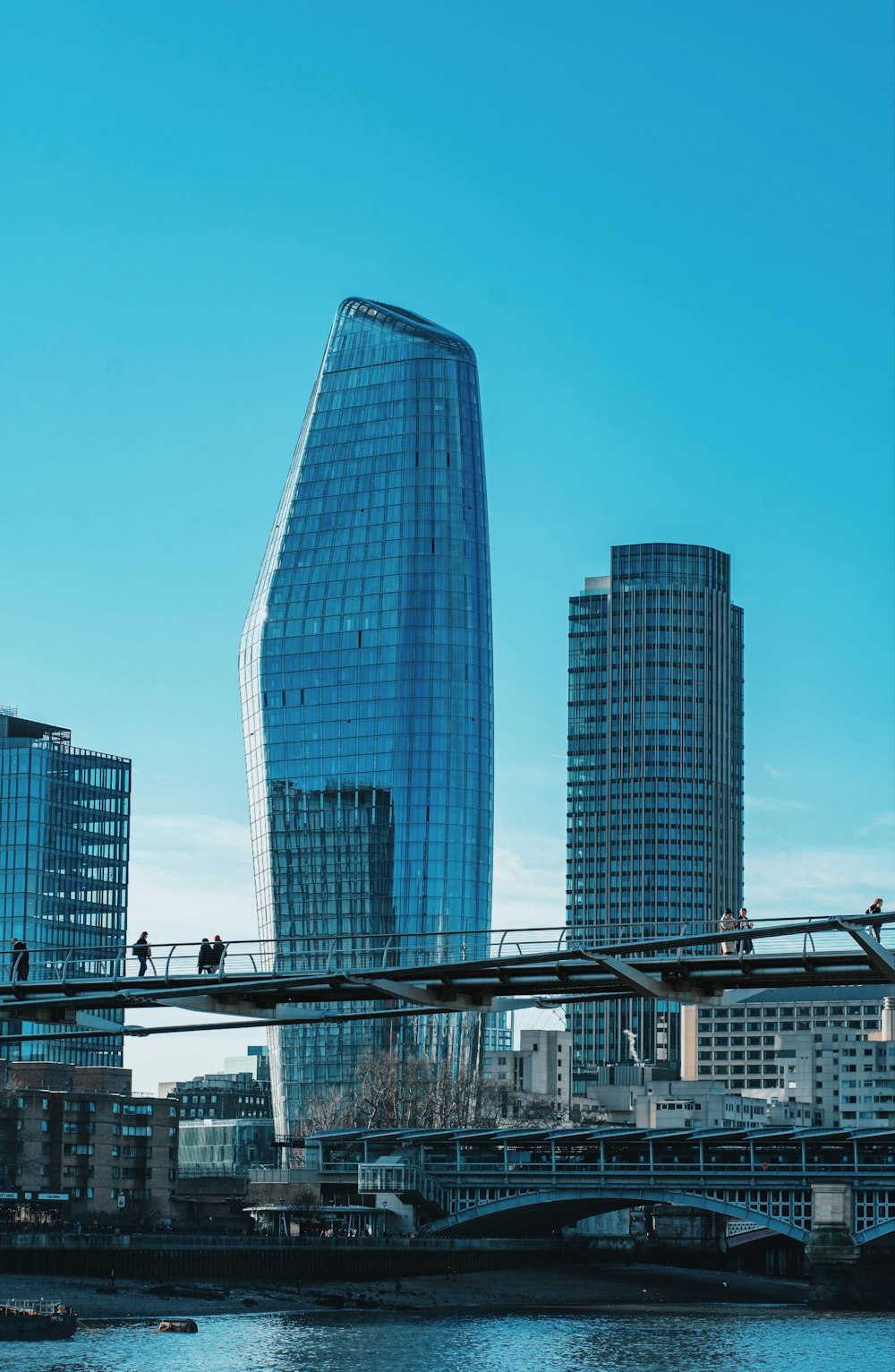 a very tall glass building towering over a city