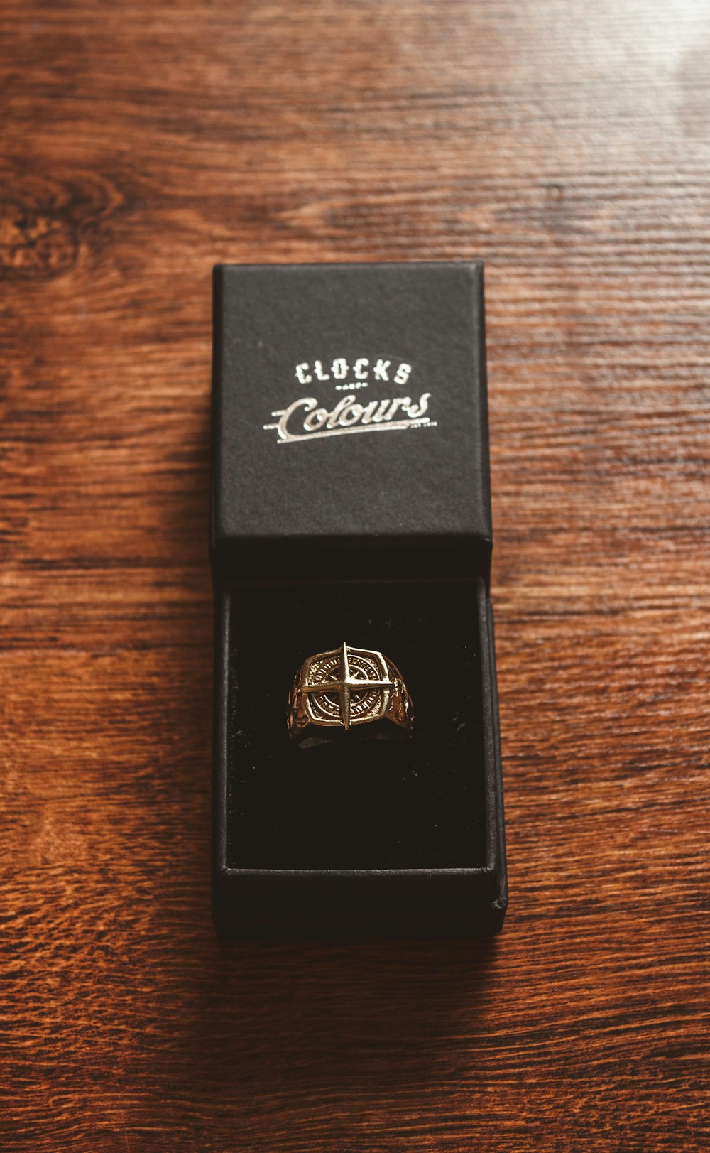 a ring in a box on a wooden table