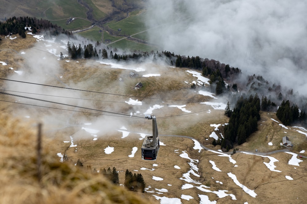 a ski lift going up a snowy mountain