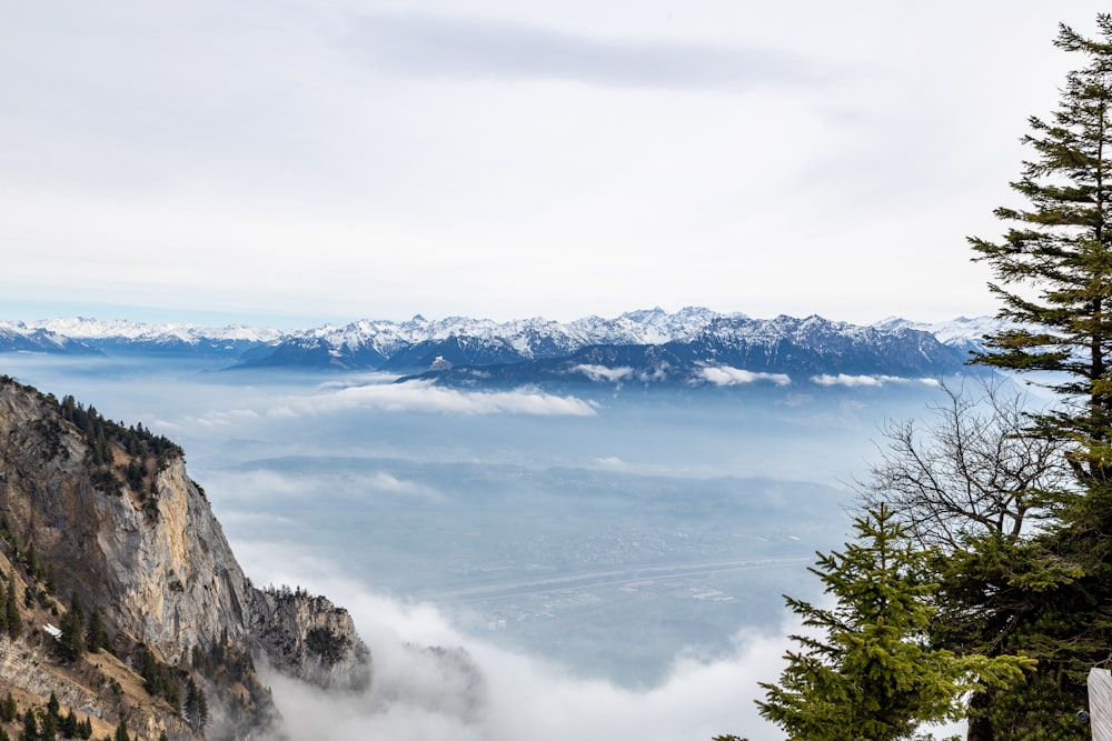 a view of the mountains and clouds from the top of a mountain