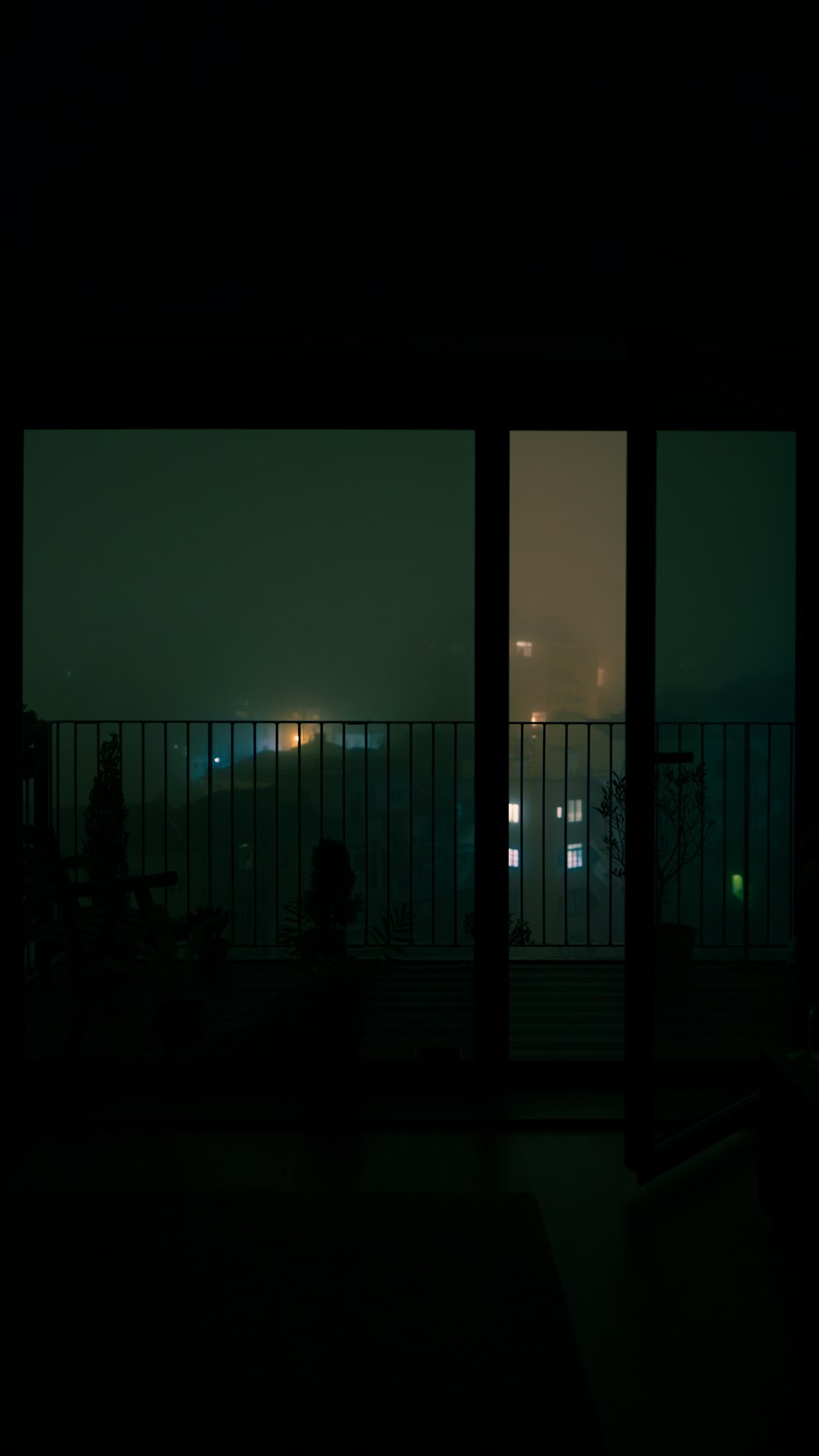 a view of a city from a balcony at night