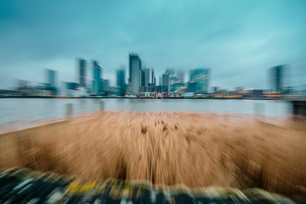 a blurry photo of a city skyline and a body of water