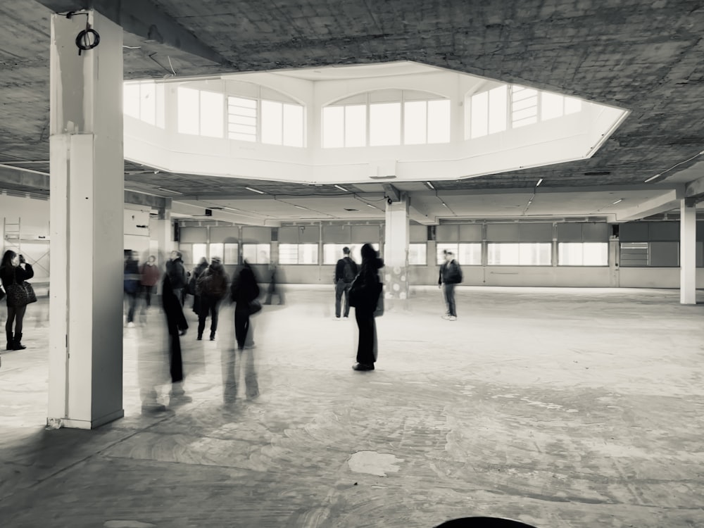 a black and white photo of people in a building