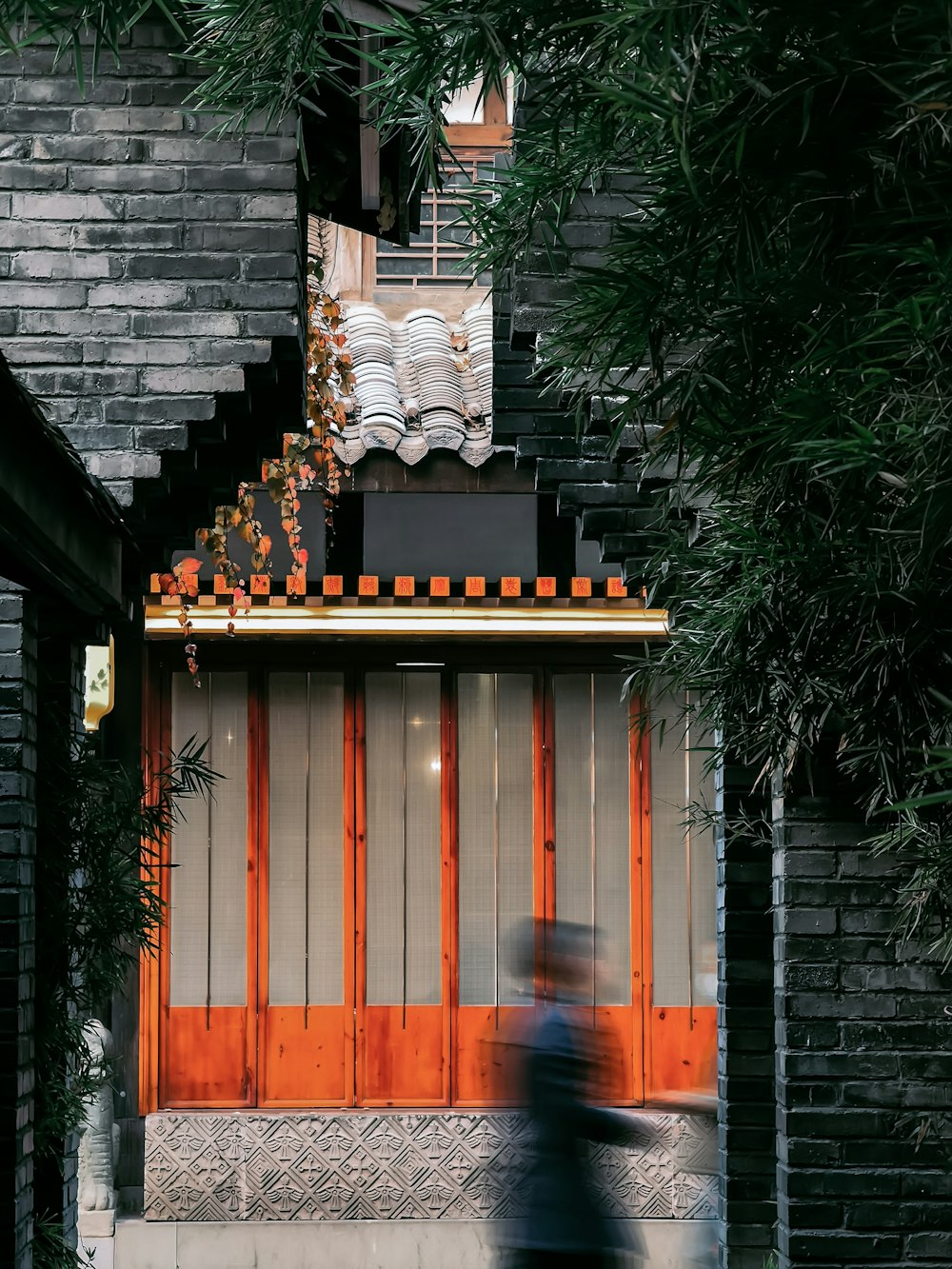 a blurry photo of a person walking past a building