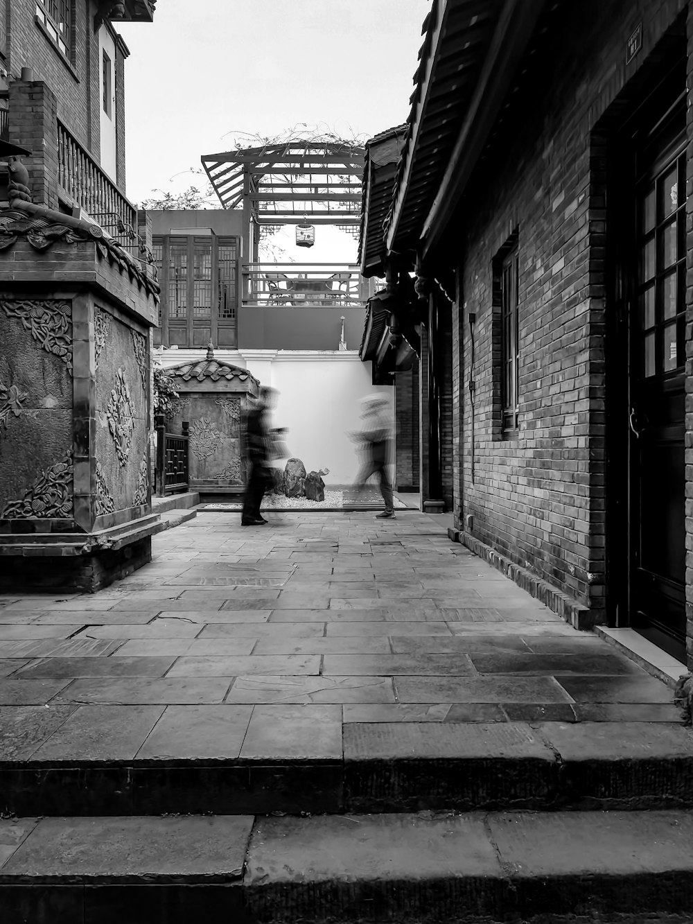 a black and white photo of a person walking down a street