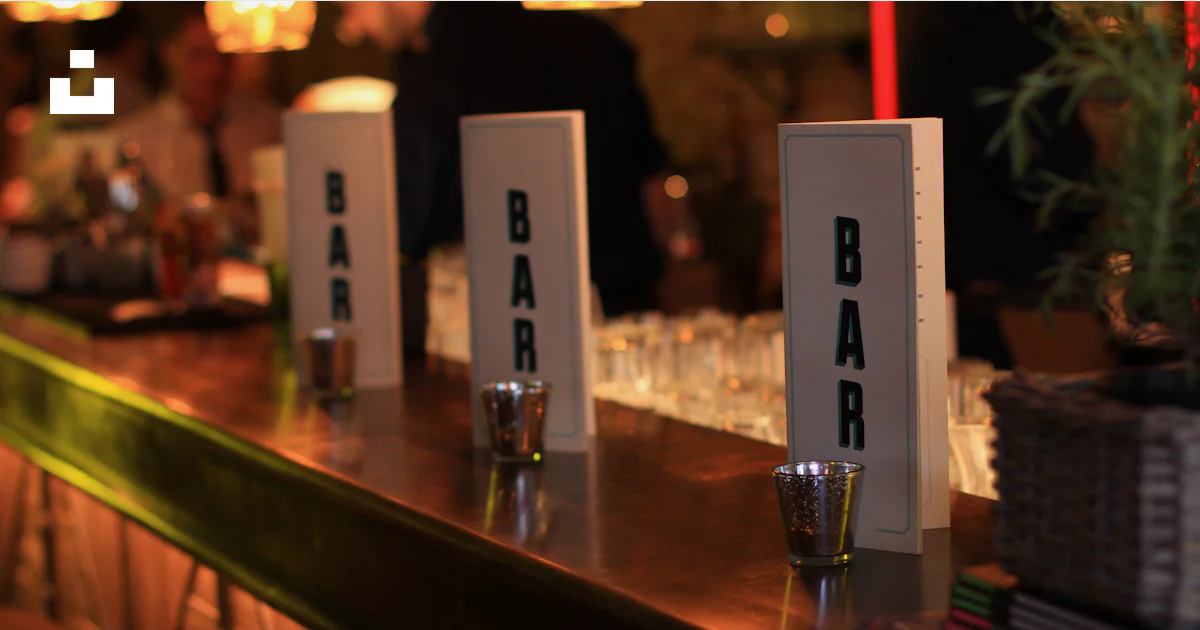 A row of bar signs sitting on top of a bar photo โ Free Restaurant ...