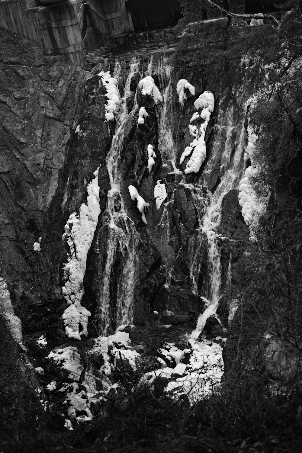 a black and white photo of a waterfall