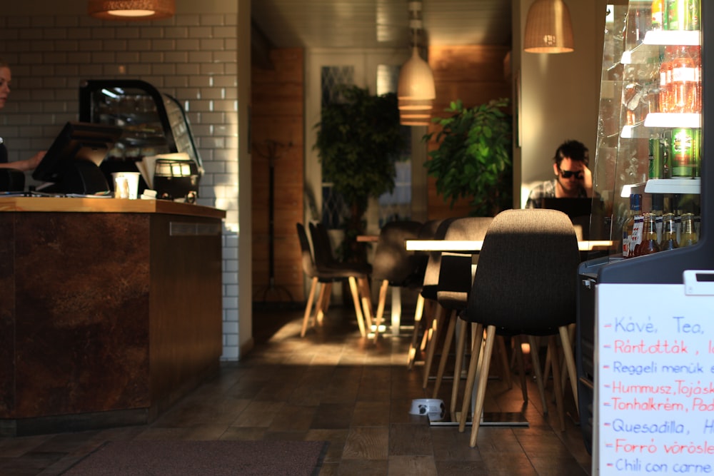 a person sitting at a table in a restaurant