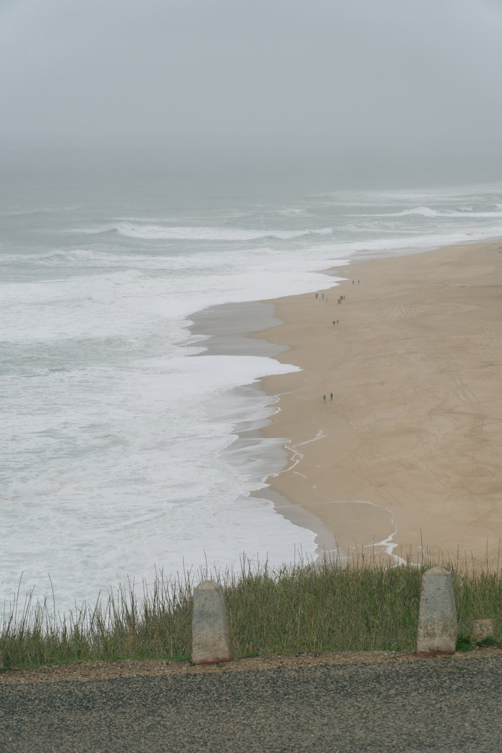 a view of a beach from the top of a hill