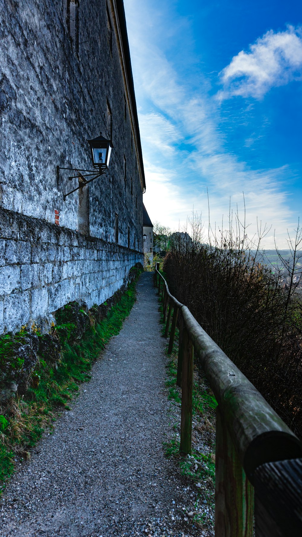 a stone building next to a wooden fence