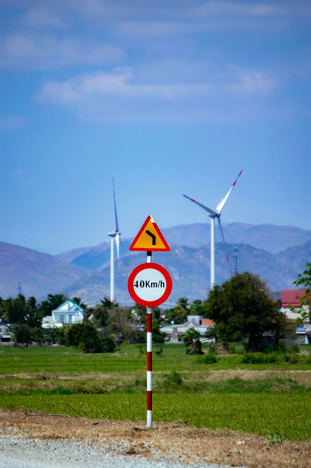 a red and white sign sitting on the side of a road