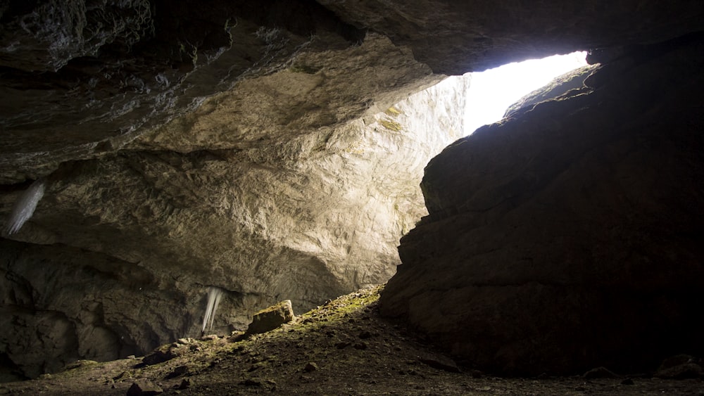 a cave with a light coming through it