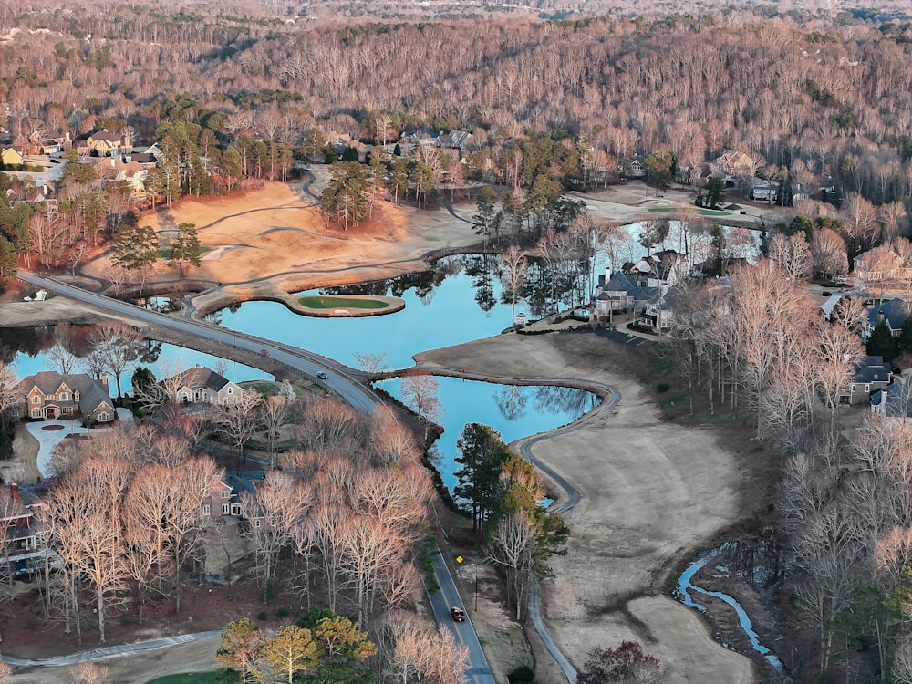 a bird's eye view of a golf course surrounded by trees