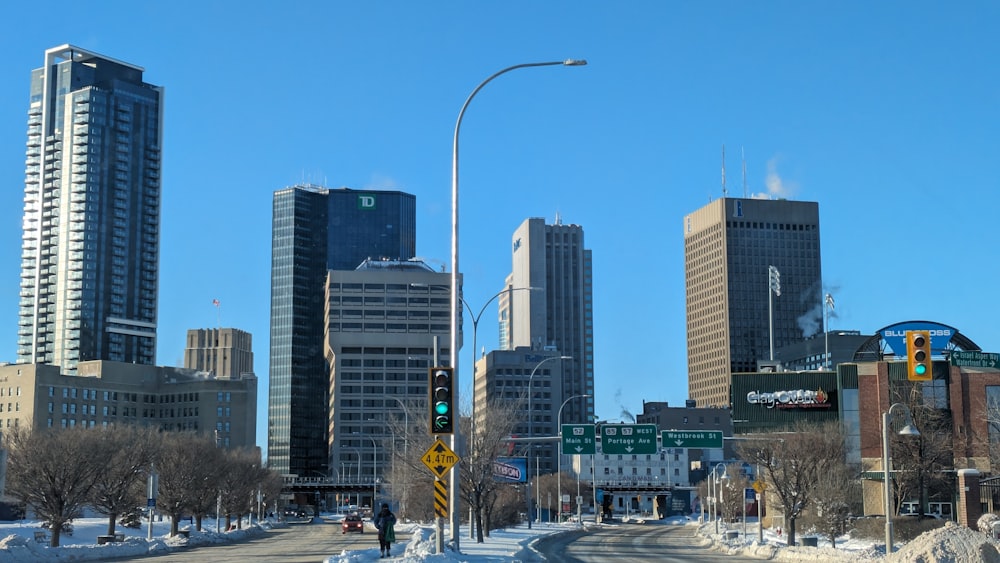 a city street with tall buildings in the background