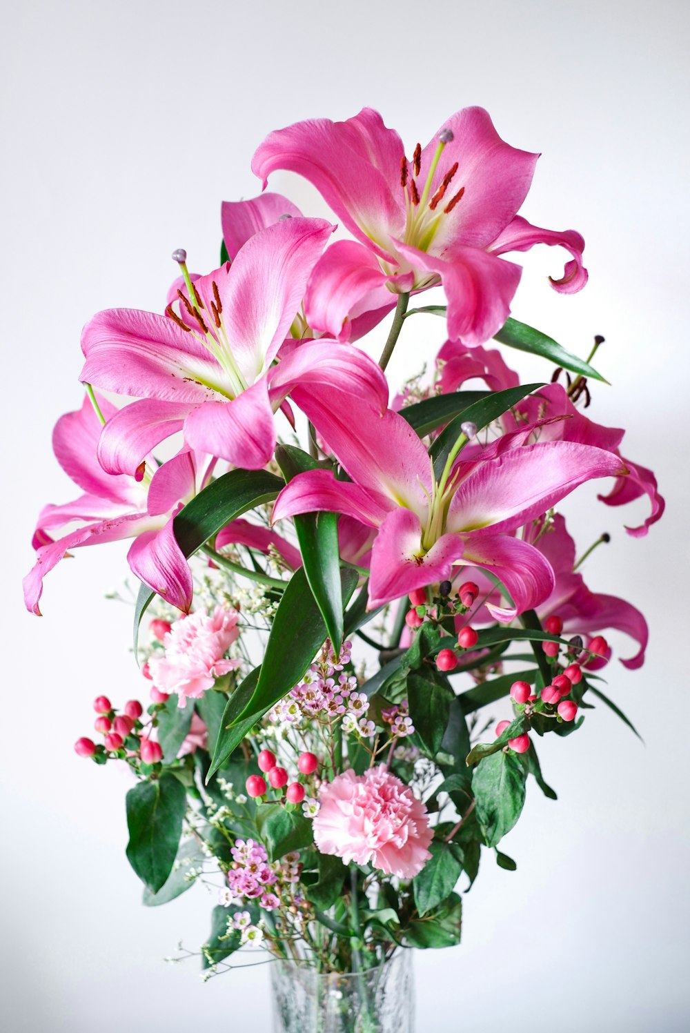 a vase filled with pink flowers on top of a table