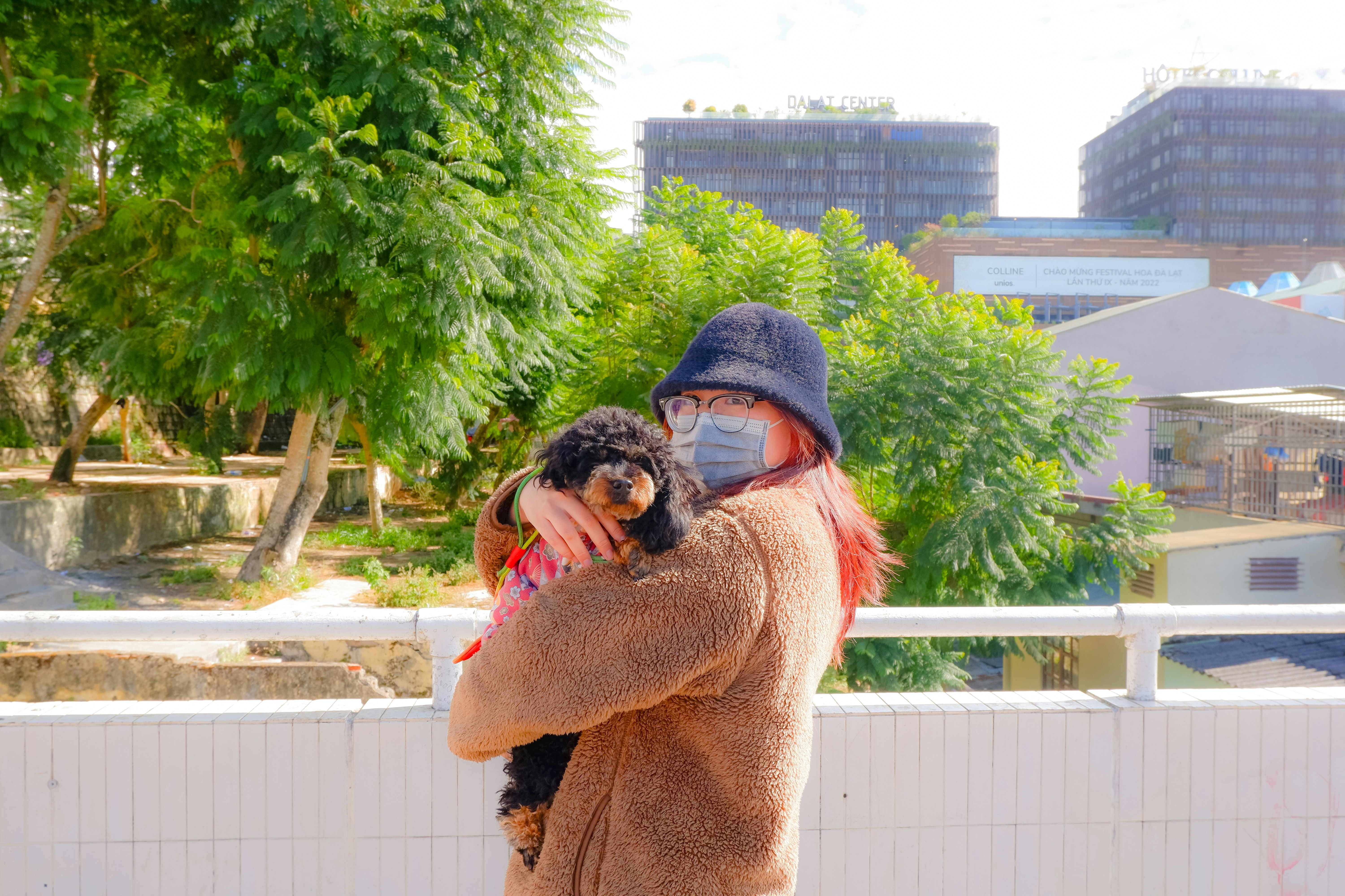 Man holding small dog in his arms