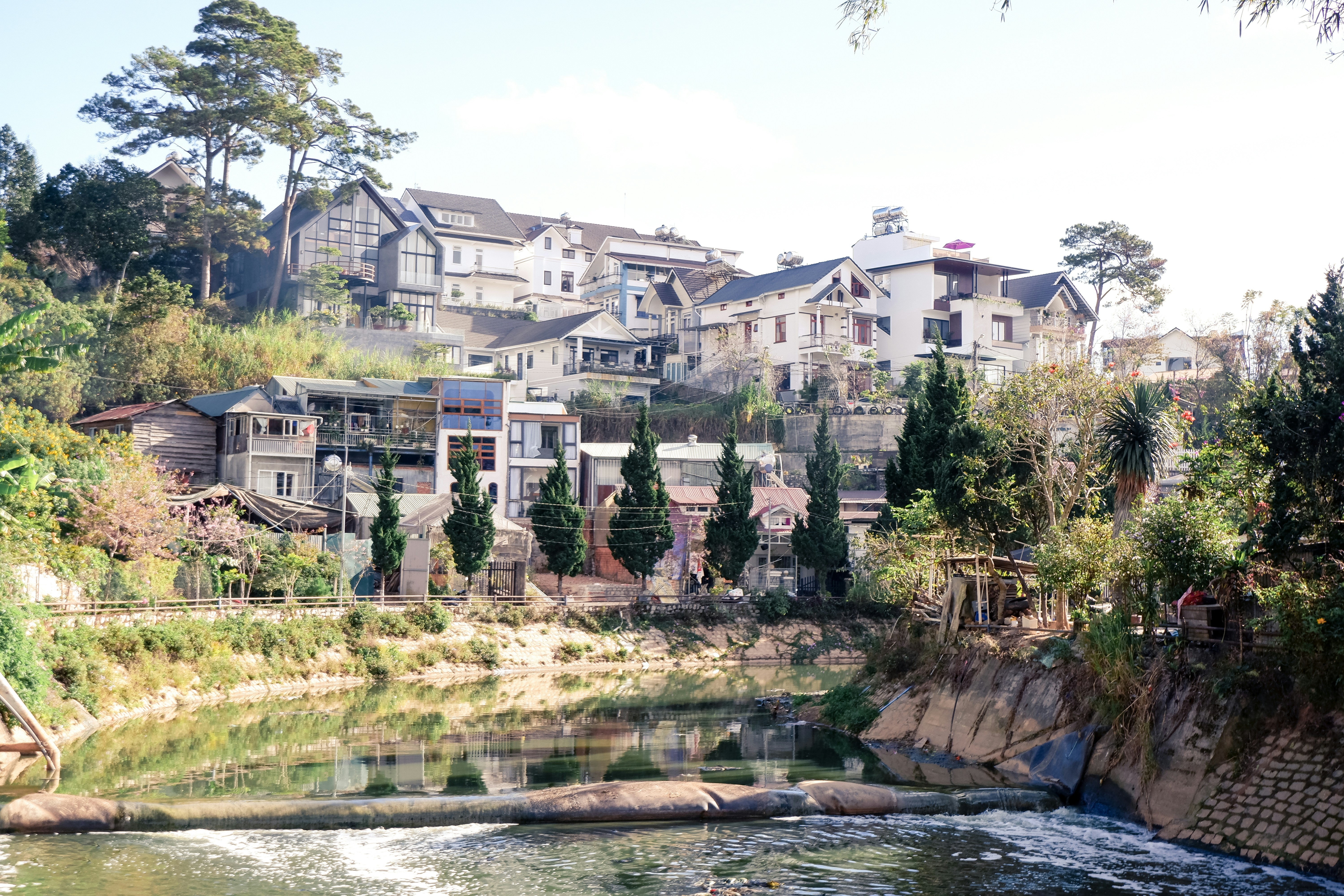 a river running through a lush green hillside