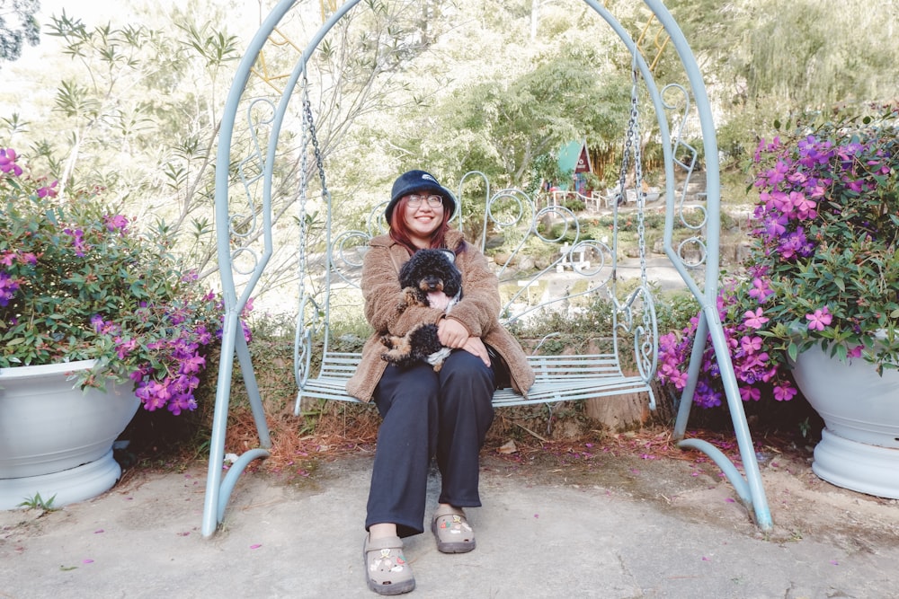 a woman sitting on a bench with a dog