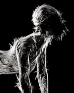 a black and white photo of a man with his head in his hands