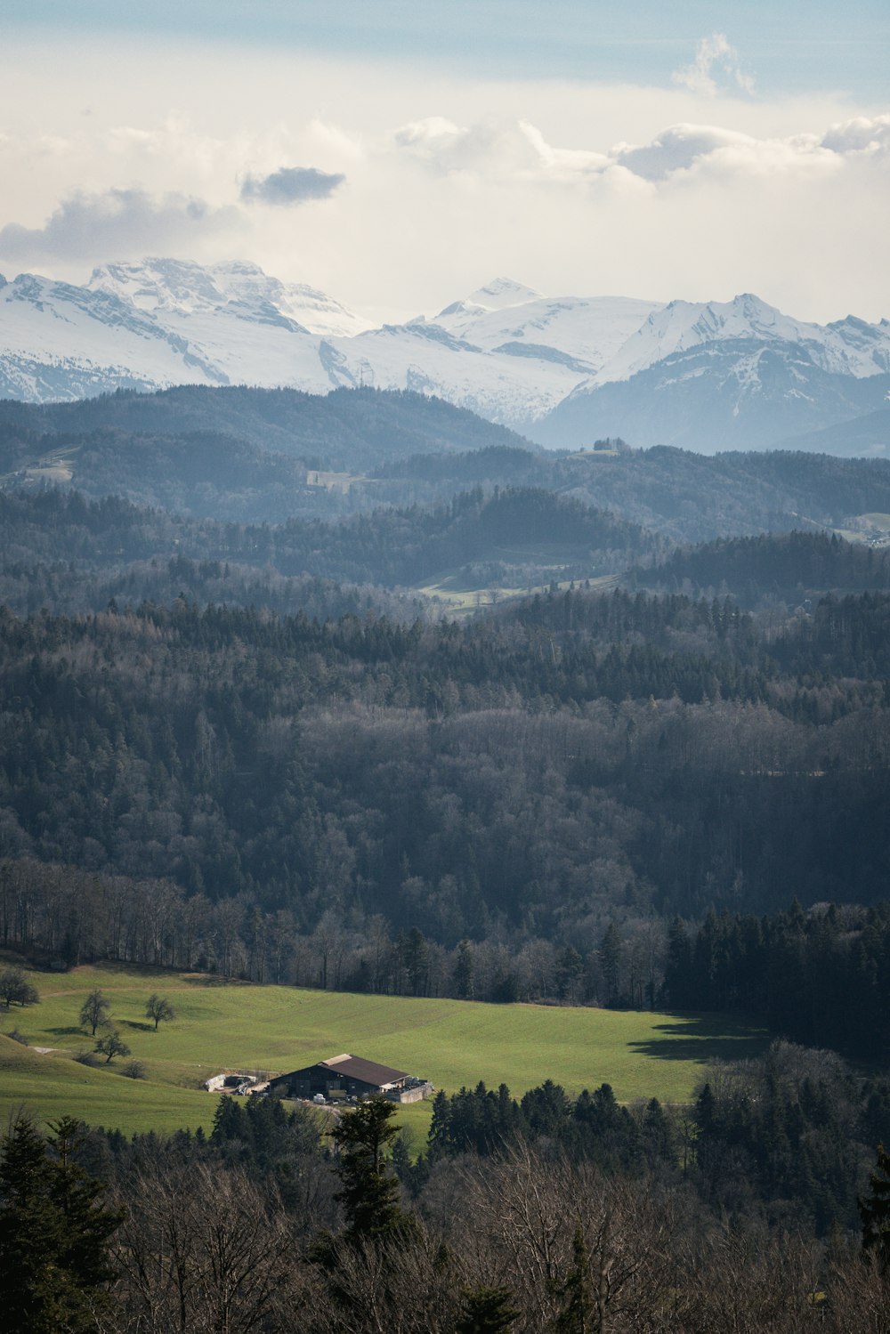 a view of a mountain range with a house in the foreground