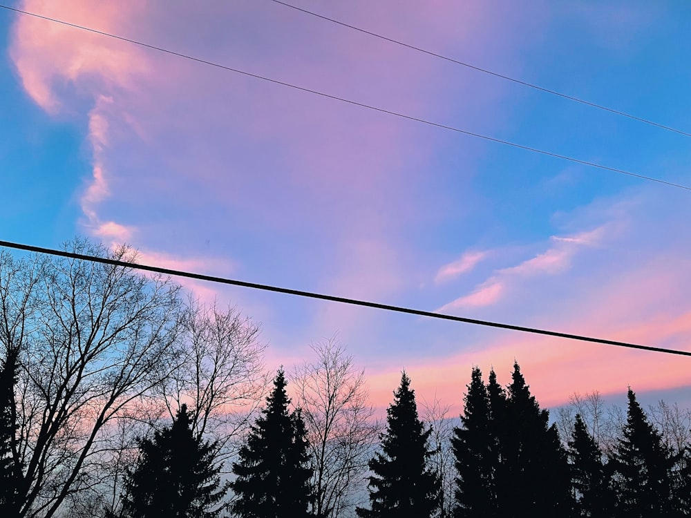 the sky is pink and blue as the sun sets