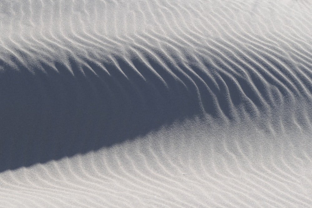 a person riding a snowboard down a snow covered slope