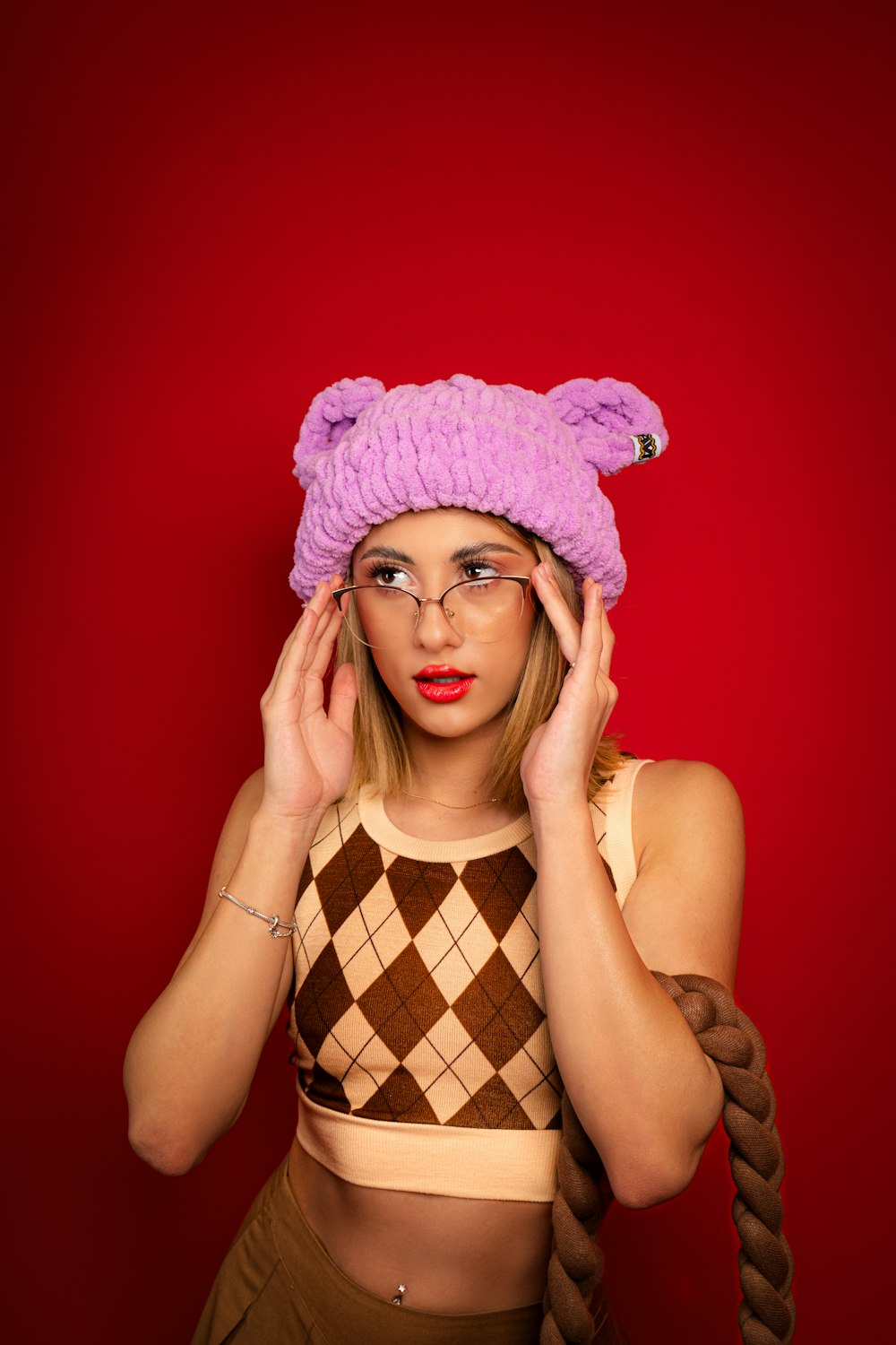 a woman wearing a pink hat and glasses