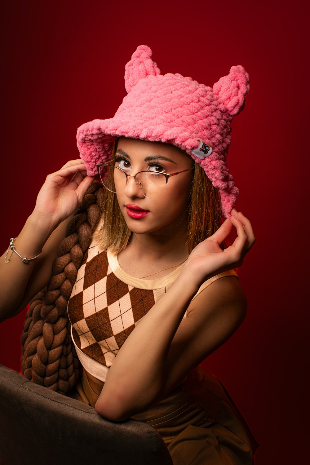 a woman wearing a pink hat and glasses