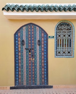 a door with a decorative design on the side of a building