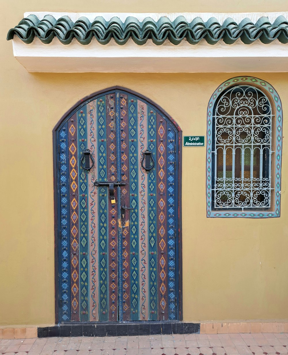 a door with a decorative design on the side of a building